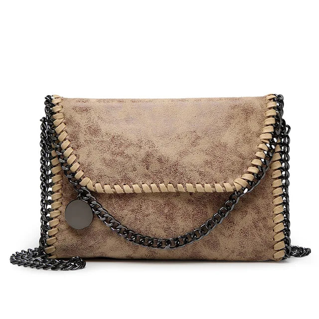 Isabel - Suede clutch with chain embellishment