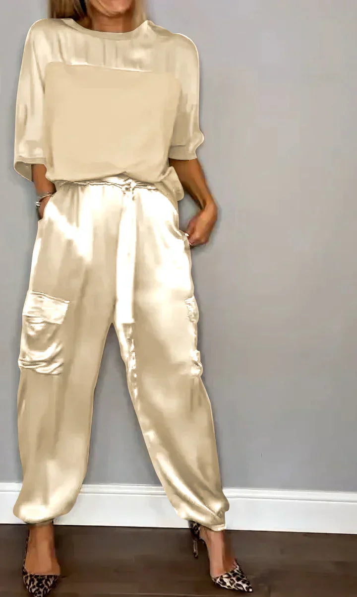 Two-piece suit in smooth satin with half-length top and trousers for women